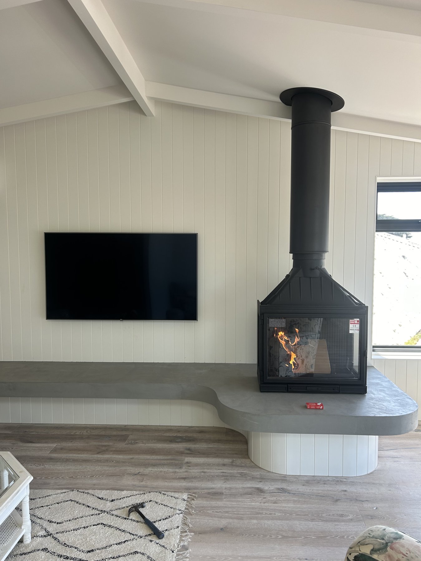 Sculptural suspended fireplace installed by Mead Air in a contemporary coastal home